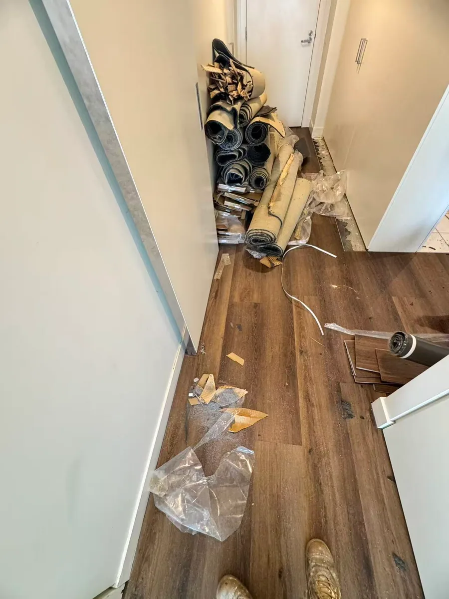 Owner-supplied photo of flooring installation work in a narrow interior area